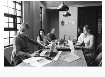 OPS team collaborating in a meeting room